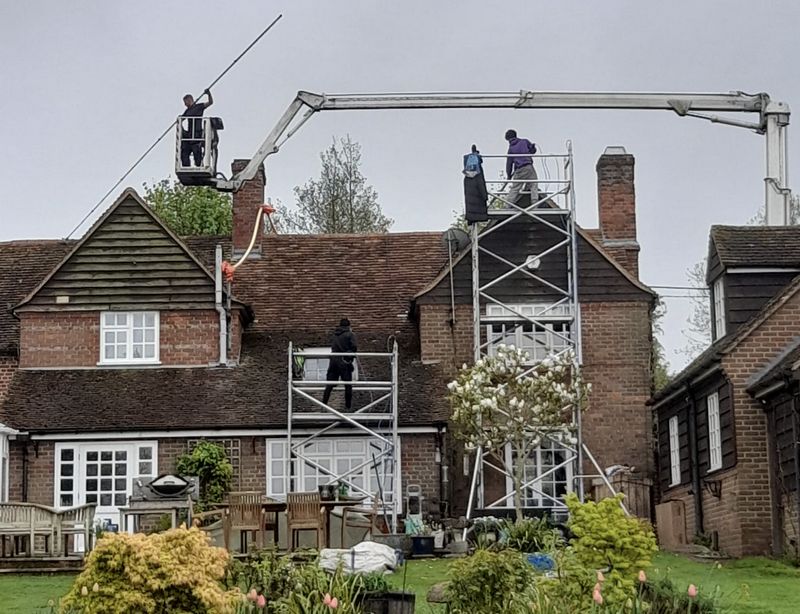 The Roof Moss Cleaners using cherry picker and scaffolding to clean roof safely and professionally in Aylesbury, Buckinghamshire